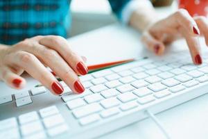 Woman office worker typing on the keyboard photo