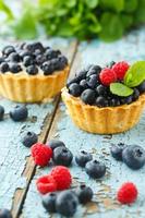 Delicious cupcake with fresh blueberry and raspberry photo