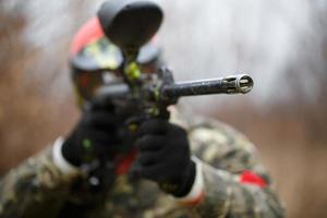 Paintball sport player wearing protective mask photo