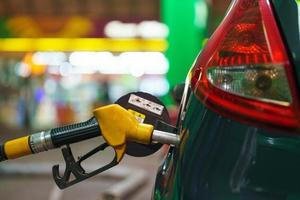 Car refueling on a petrol station in winter at night photo