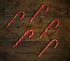 Candy canes on wooden boards photo