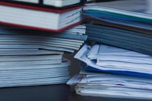 Accounting and taxes. Pile of magazine, notebook and books closeup photo