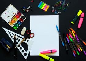 School supplies on blackboard background ready for your design photo