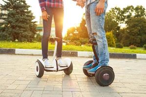 Young couple riding hoverboard photo