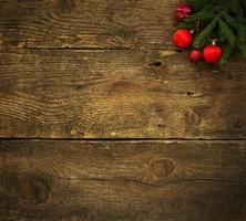 Christmas tree branches with christmas decorations on wooden texture ready for your design photo