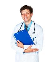 Portrait of smiling young male doctor writing on a patient's medical chart on white photo