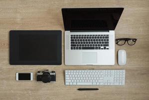 Top view of business workplace with laptop and gadgets photo