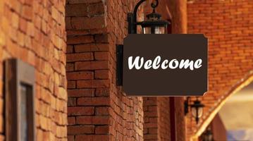 Outdoor brown sign with message Welcome photo