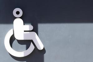 Light box icon handicapped toilet on gray wall in gas station photo