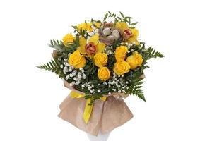 Decorated bouquet of yellow roses with bird's nest and eggs. photo