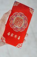 hand holding red envelope gift chinese new year photo