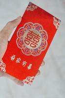 hand holding red envelope gift chinese new year photo