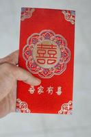 hand holding red envelope gift chinese new year photo