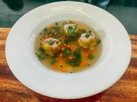 hotel resort food Asian style dumpling in clear chicken consomme soup with scallion photo