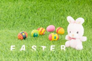 Bunny toy and Easter eggs with text photo