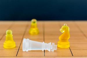 Chess glass on a wood chessboard photo