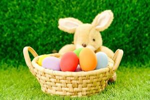 Bunny toy and Easter eggs in basket photo