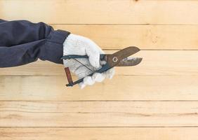 Hand in glove holding plier photo