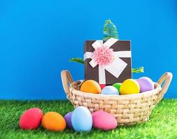 Easter eggs in the basket on green grass photo