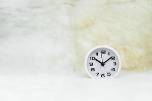 White alarm clock on table photo