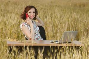 Beautiful woman or business woman talking on a cell phone outside. Outdoor portrait of a beautiful happy businesswoman talking on cell phone. photo