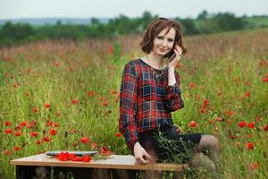 Beautiful woman or business woman talking on a cell phone outside. Outdoor portrait of a beautiful happy businesswoman talking on cell phone. photo