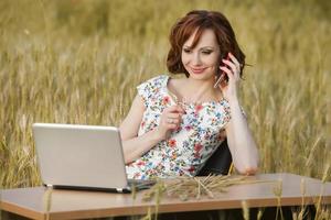 Beautiful woman or business woman talking on a cell phone outside. Outdoor portrait of a beautiful happy businesswoman talking on cell phone. photo