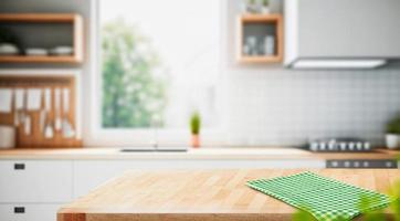 Wood table top on blurred kitchen background. can be used mock up for montage products display or design layout photo