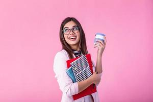 Smiling girl student or woman teacher portrait with books and coffee to go in hands. education, high school and people concept - happy smiling young woman teacher in glasses photo