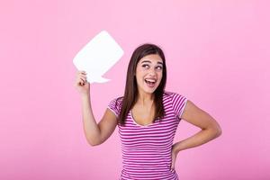 Amazing offer. Overjoyed girl holding empty speech bubble over pink studio background. photo