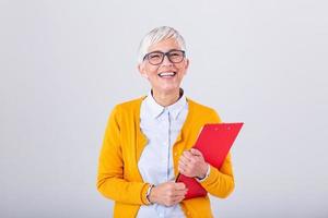 Mature beautiful smiling business woman with glasses isolated on background. Business concept with clipboard and document in hands. Mature business women With clipboard in hand with copy space photo
