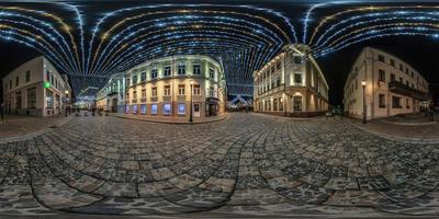 spherical seamless night hdr 360 panorama on pedestrian street with stone pavement of old town with festive decoration and illuminations in equirectangular projection photo