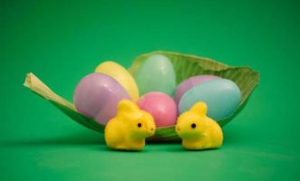 Easter scene with bunnies and colourful eggs in a fresh cabbage leaf photo