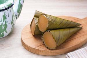 Clorot, Indonesian traditional cake made from rice flour with coconut milk, wrapped in young coconut leaves or banana leaves in a cone shape. photo