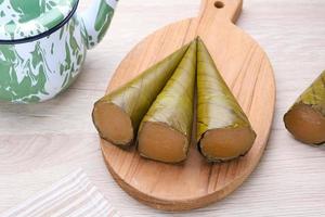 Clorot, Indonesian traditional cake made from rice flour with coconut milk, wrapped in young coconut leaves or banana leaves in a cone shape. photo