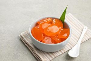 Manisan Kolang-Kaling, or preserved sugar palm fruit with orange color, Indonesian drink and dessert during the month of Ramadan. photo