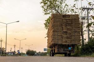 A section of an agricultural vehicle loaded with bales of straw. photo