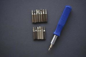 Replaceable nozzles for a screwdriver. Blue screwdriver with attachments. photo