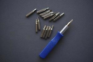 Replaceable nozzles for a screwdriver. Blue screwdriver with attachments. photo