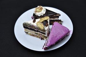 Delicious sweet cakes on a plate. Sliced cake with nuts and sweets. Sweet cake. photo