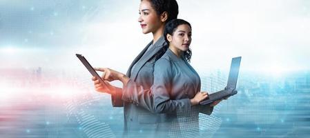 Double exposure of businesswoman using tablet and laptop on world map background, Business innovation technology digital futuristic global network interface concept, Programmer, IT support, Copy space photo