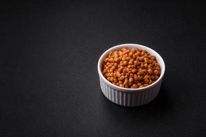 Delicious healthy canned lentils in a ceramic ribbed white bowl photo