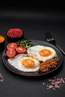 Delicious hearty breakfast consisting of two fried eggs, canned lentils and microgreens photo