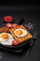 Delicious hearty breakfast consisting of a fried egg, Belgian waffle photo