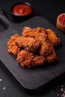 Delicious crispy breaded chicken wings grilled with spices and herbs photo