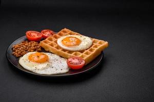 Delicious hearty breakfast consisting of a fried egg, Belgian waffle photo