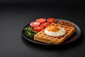 Delicious hearty breakfast consisting of a fried egg, Belgian waffle photo