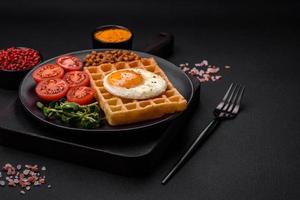 Delicious hearty breakfast consisting of a fried egg, Belgian waffle photo