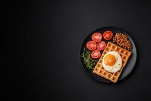 Delicious hearty breakfast consisting of a fried egg, Belgian waffle photo