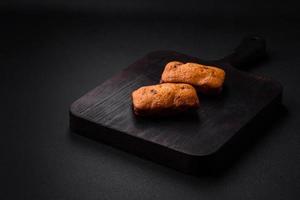 Delicious chocolate muffins and dried round shaped slices of tangerine photo